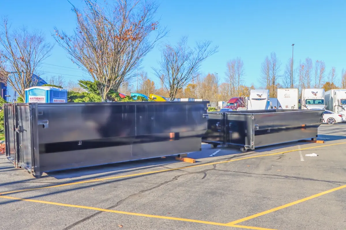 Professional dumpster rental service with roll-off container on residential driveway in Lone Grove